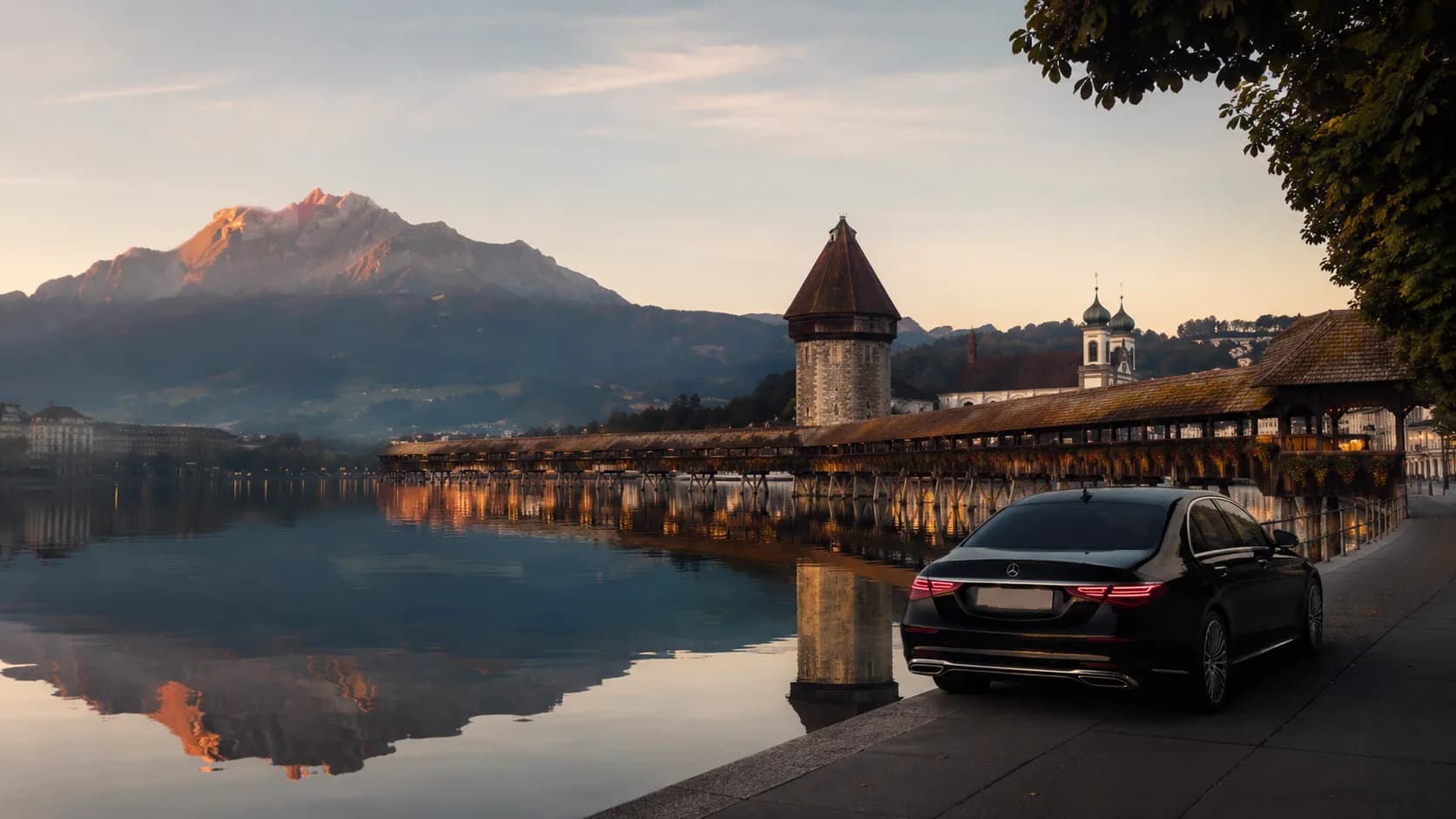 Chapel Bridge in Lucerne at sunrise with Mount Pilatus in the background